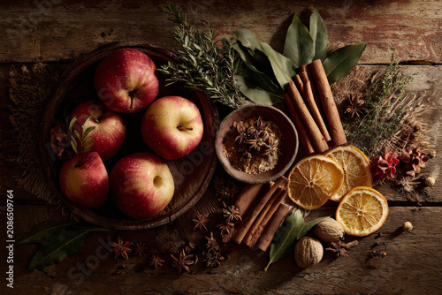 Autumn harvest ingredients for mulled cider and baking, including apples, cinnamon, oranges, and spices.