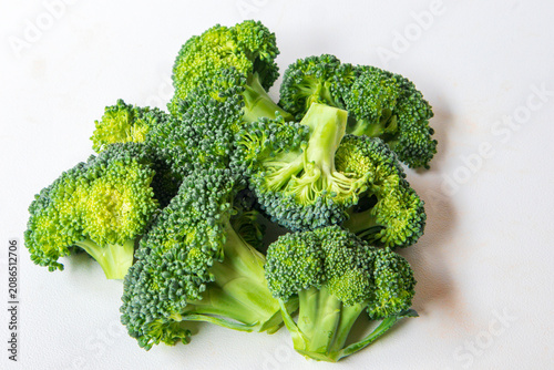Pile of Fresh raw broccoli florets isolated on white background. Top View. A heap of Fresh broccoli cuts 