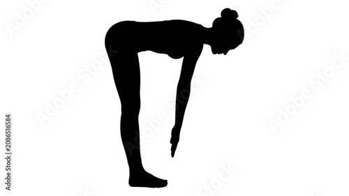 Photos Woman silhouette performs a forward fold yoga pose against a clean white background