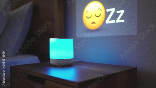 Glowing light device projects sleep emoji on bedroom nightstand. Suitable for promoting cozy bedroom decor and relaxation products.