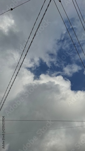 Power pole and cables against textured cloudy sky