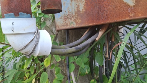 Electrical utility box mounted on rusty pole
