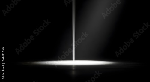 Cinematic spotlight beam hitting a dark floor with subtle dust in a black background room.