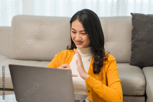 Young deaf asian woman showing sign language. a woman with hearing disability having communication with hands gestures Communicate online using sign language via a laptop.