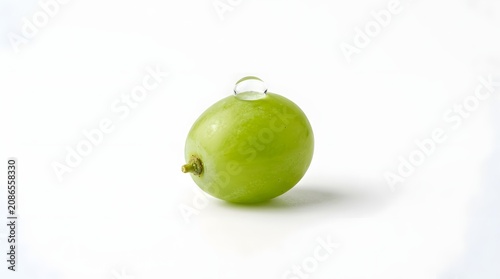 Single green grape with a water droplet isolated on white background