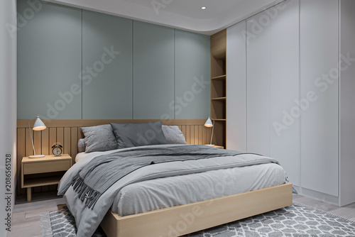 Fotografie A bedroom in a luxury house, sleek and kingsize bed with the lamp on both-side console table
