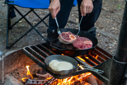 Cooking Steak over Campfire in Cast Iron Skillet