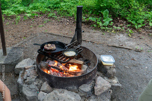 Cooking Steak over Campfire in Cast Iron Skillet