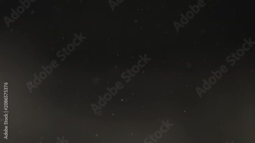 Floating dust particles over dark background with shallow focus