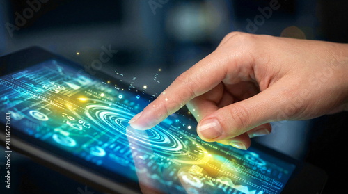 Human hand interacting with digital tablet interface screen overlays.