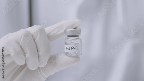 Professional doctor wearing white glove on hand holds medical vial offering scientific medicine dose treatment option for patient starting healthy weight loss journey with care