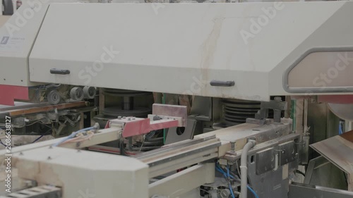 Close-up of industrial woodworking machinery processing timber in a factory workshop