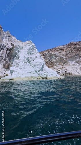 Sailing along the white beach in santorini, greece