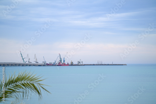 Obraz na plátne Manfredonia port with industrial cranes and a freight ship