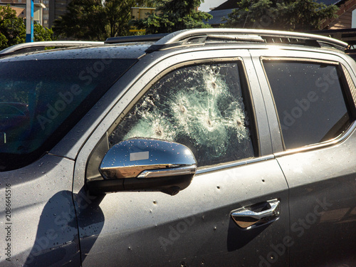 фотографія Bulletproof car window shattered by multiple gunshots after a violent shooting a