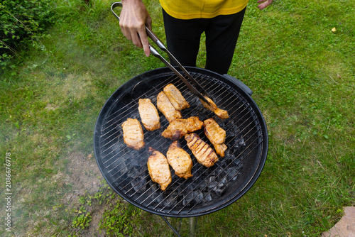 meat is being cooked on the barbecue. A light smoke is spreading over it