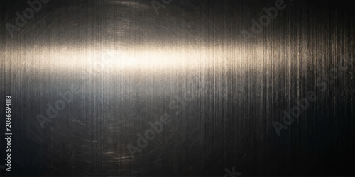 Tableau sur toile A brushed metal surface with vertical striations reflects a bright light, creating a textured, industrial backdrop