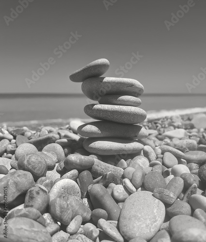 monochrome view of stack of zen pebbles on the seashore