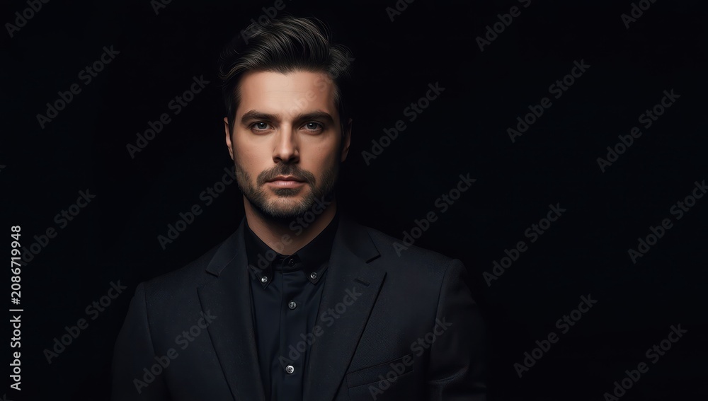 Fototapeta premium Businessman in suit against dark backdrop with space for text.