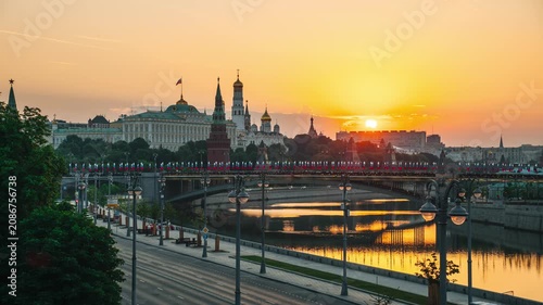 A morning view of the Moscow River, the Kremlin, St. Michael the Archangel's Cathedral, and the Grand Kremlin Palace, with the sun rising over the horizon — time-lapse photography