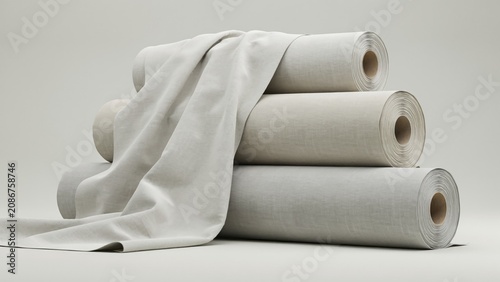Stack of rolled beige linen fabric bolts with draped textile
