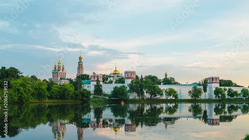 A timelapse of rapidly moving clouds in the sky at sunset over the Novodevichy Convent in Moscow