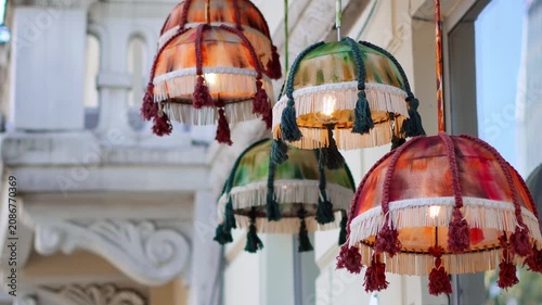 Ornate vintage boho pendant lamps with colorful fabric fringe and tassels.