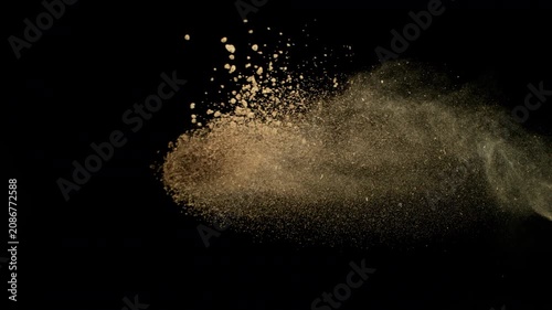 Super Slow Motion Shot Flying Soil Isolated on Black at 1000fps.