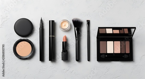 Collection of makeup products including powder, eyeliner, lipstick, brushes, and an eyeshadow palette on a light gray textured background