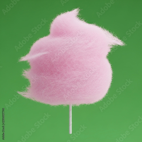 Pink cotton candy on a stick against green background