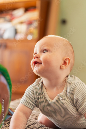 Εκτύπωση καμβά Adorable baby with drool on chin looking up with a happy expression
