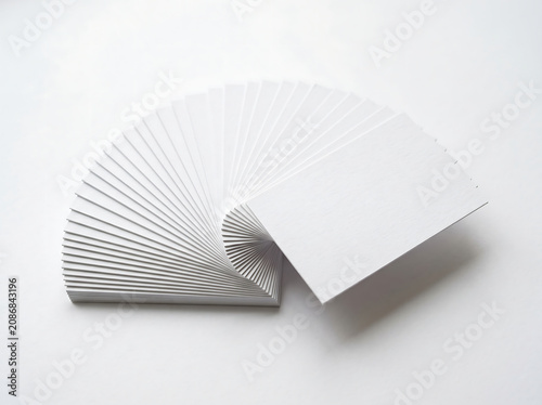 Stack Of Blank White Business Cards Fan Shaped On Plain White Background With Modern Texture Edge