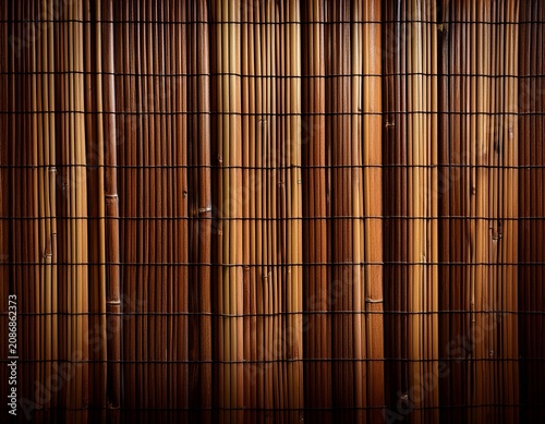 bamboo wall texture showcasing a rich brown linear pattern with vertical bamboo stalks arranged closely together against a dark backdrop