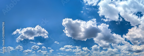 Wide detailed panorama of the sky with a large number of clouds. Spacious summer clear space with cloud flying towards the wind. Uniform filling with white spots of diagonal movement