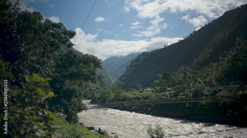 High Angle View of Muddy Alpine River Flowing Through Mountain Valley Landscape