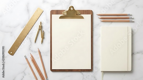 Study and design tools on marble surface overhead view