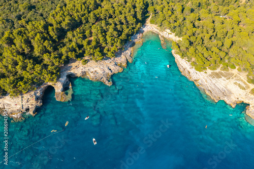 фотографія Top-down aerial view of crystal-clear turquoise water, natural sea caves, limest