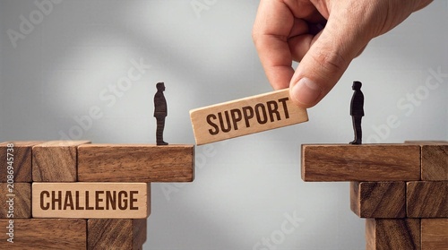 Hand building wooden bridge with support block to overcome challenge concept.