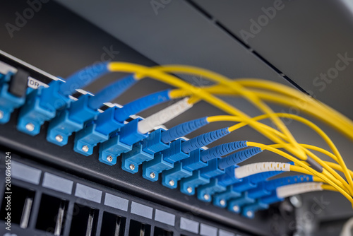 Canvastavla Blue LC duplex fiber optic connectors and yellow single-mode cables in server ra
