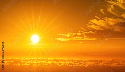 The sun shines brightly in a cinematic wide-angle shot of a golden-orange summer sky during peak heatwave conditions.