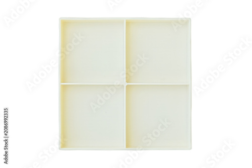 Square light plate with four separate sections isolated on white background. White tableware. Top view.