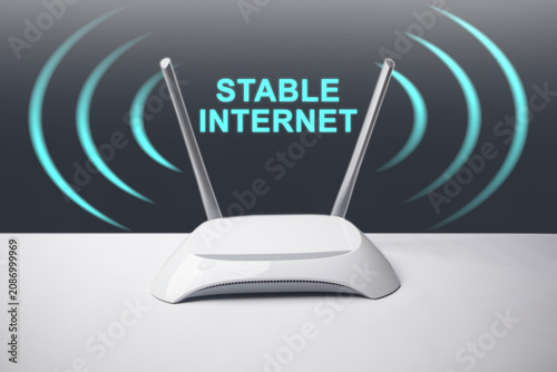 A conceptual image featuring a minimalist white wireless internet router with two antennas, surrounded by glowing blue signal waves and the overlay text STABLE INTERNET.