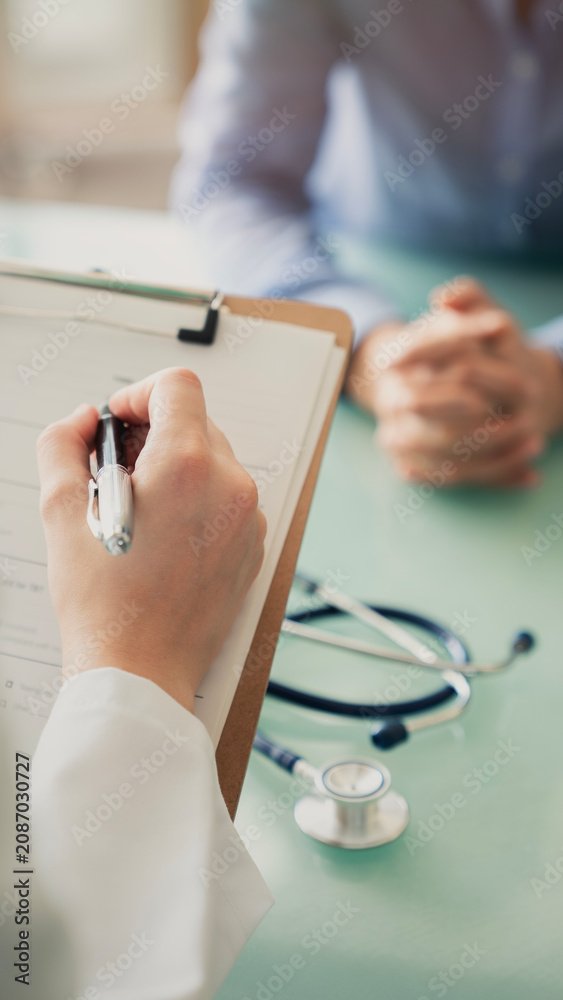 Fototapeta premium Doctor filling out the anamnesis form