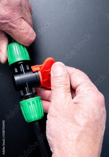  Drip irrigation shutoff valve being turned