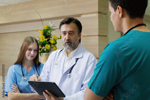 professor doctor give advice and discussing with intern student team for surgery planning and patient treatment in the hospital medical university. healthcare and medical education concept.