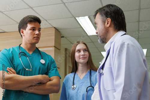 professor doctor give advice and discussing with intern student team for surgery planning and patient treatment in the hospital medical university. healthcare and medical education concept.