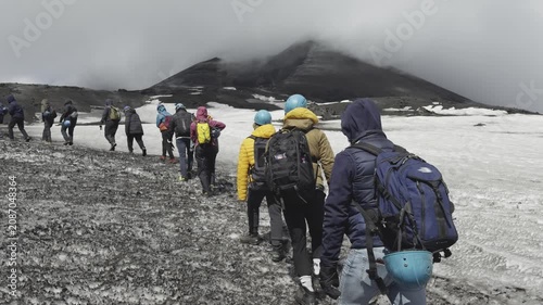 Adventurers climbing dramatic slopes of Mount Etna active volcano