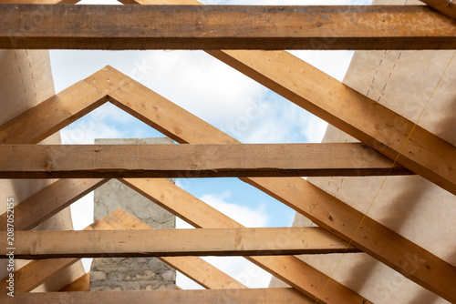 Canvastavla Wooden roof trusses and beams forming the framework of a new house, a significan