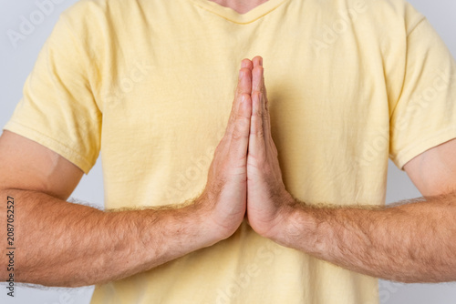 Obraz na plátně Man with hands pressed together in a prayerful namaste pose, expressing spiritua