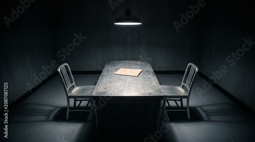 Photos Interrogation room with metal table, folder and hanging lamp